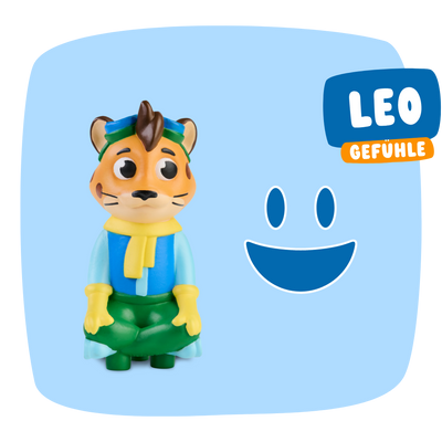 Die Leo "Meine Gefühle" Spielzeug-Tigerfigur von Edurino DE trägt blaue und grüne Kleidung, hat den Text LEO GEFÜHLE, ein blaues Smiley-Gesicht und betont soziale Stärke & Empathie auf blauem Hintergrund.